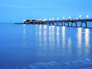 Boardwalk Prints: Evening light reflects on the water at the pier in Deal Kent during dusk hours