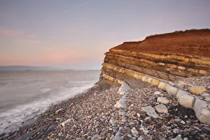 Evening light on rocks and the cliff at Kilve beach, Kilve, near Nether Stowey, Somerset