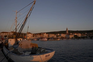 Brac Prints: Evening light in Supetar, with fishing boat in front, Brac, Dalmatian Coast