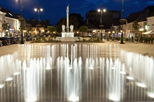 Evening scene around Baroque Plague Column, Hauptplatz Square, Tulln, Niederosterreich