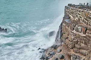 Ocean Waves Prints: Evening shoreline, Atlantic surf crashing against the harbour wall at Hartland Quay