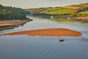 Regional Prints: Evening sunlight highlights the estuary of River Avon at Bantham in south Devon