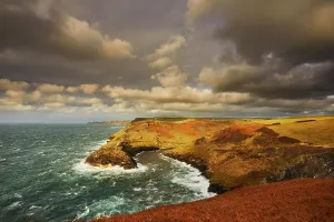 United Prints: Evening sunlight illuminates cliffs at Boscastle harbour on the Atlantic coast in Cornwall