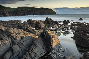 Evening sunlight on the rocky shores of Hope Cove, Devon, England, United Kingdom, Europe
