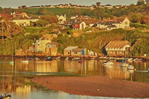 Vessel Prints: Evening sunlight view of the River Avon estuary with boats and village in Devon