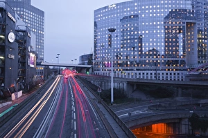 Tail Light Prints: Evening traffic flowing through the La Defense area of Paris, France, Europe