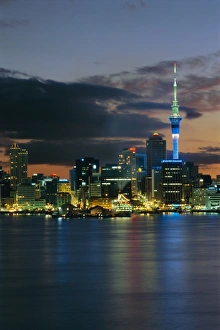 Central Auckland Prints: Evening view of city skyline across harbour