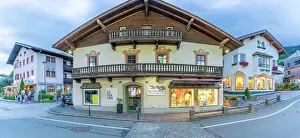 Businesses Prints: Evening view of shops in Kaprun during summer highlighting local culture and architecture in Austria