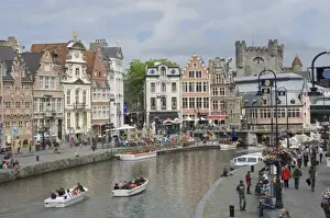 Everyday scene along the Graslei bank, lined with Baroque style Flemish gabled houses, Gravensteen Castle beyond, in the centre of Ghent, Belgium, Europe