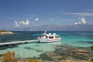 Corsica Prints: Excursion boat moored at jetty in clear turquoise water off the Plage du Loto