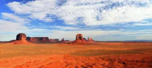 Iconic Prints: Expansive view of Monument Valley with red rock formations under a blue sky in Utah