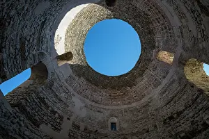 Atmosphere Prints: Exploration of ancient architecture in cellars showing circular structure and blue sky in Croatia