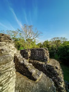 Sites Prints: Exploration of ancient ruins at Uaxactun Archaeological Site in Guatemala during a clear day