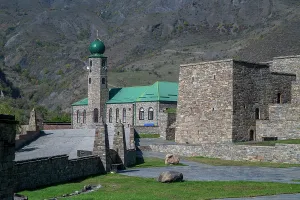 Stones Prints: Exploration of the central mosque in Itum-Kali with stone structures and mountains in the background