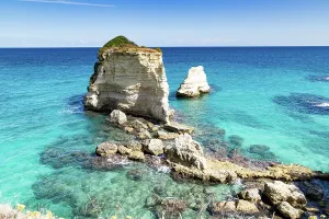 Salento Prints: Explore the faraglioni di Sant Andrea in Salento Italy during a sunny day near the clear blue sea