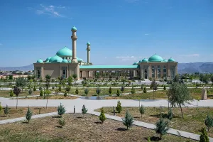 Domes Prints: Explore Haydar Mosque in Nakhchivan and its large garden in Azerbaijan with clear skies and mountains in the background