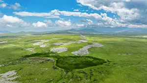 Meadow Prints: Explore highland scenery around Qarabaqh in Azerbaijan featuring vast greenery and bright blue skies