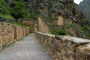 Peru Prints: Explore Inca ruins and stone pathways at Ollantaytambo archaeological site in Peru surrounded by mountains and greenery