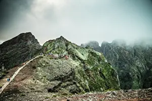 Slopes Prints: Explore the mountain landscape of Madeira Portugal with steep trails and lush greenery under a cloudy sky