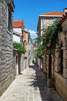 Streets Prints: Explore narrow stone streets lined with flowers in the old city of Stari Grad