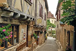 Cobblestone Prints: Explore the narrow street of Saint-Cirq-Lapopie with its old buildings and charming decorations