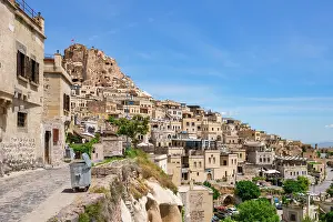 Cappadocia Prints: Explore Uchisar town with traditional houses under clear blue skies in Cappadocia, Turkey