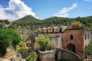 Ambiance Prints: Exploring the abandoned houses and church in Kayakoy ghost town surrounded by mountains and vegetation in Fethiye