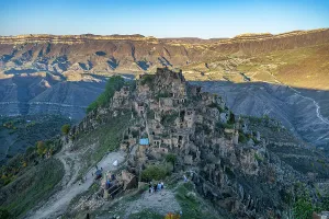 Dirt Prints: Exploring the abandoned village of Gamsutl with stone buildings on a hill in Dagestan