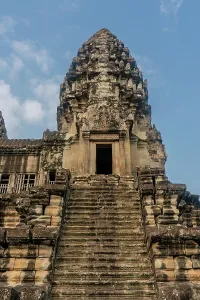 Southeast Prints: Exploring the ancient architecture of Angkor Wat in Siem Reap Cambodia with stone steps and cloudy sky