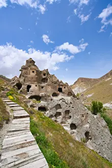 Cappadocia Prints: Exploring ancient houses carved into rock formations in Cappadocia Turkey with scenic landscape