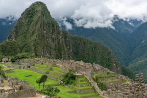 Terraces Prints: Exploring the ancient ruins of Machu Picchu with mountains and clouds in the background in Peru