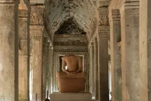 Columns Prints: Exploring the ancient ruins of Ta Prohm Temple with a stone statue in Cambodia