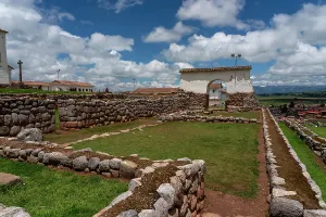 Peru Prints: Exploring ancient stone walls and grassy areas at Chinchero archaeological site in Peru on a cloudy day