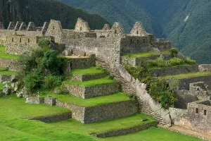 Trail Prints: Exploring the ancient structures and terraces at Machu Picchu in Peru under clear blue sky
