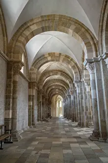 Columns Prints: Exploring the architectural details of Vezelay Abbey's cloister in France with tall arches and stone walls