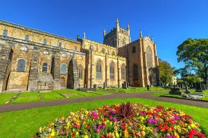 Landscaping Prints: Exploring the architecture of Dunfermline Abbey with colorful flowers in the foreground in Dunfermline