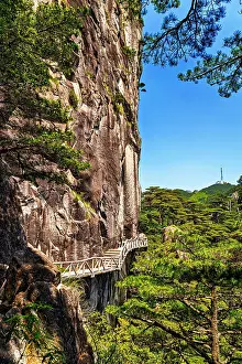 Walkway Prints: Exploring cliffside walkway along the rugged terrain of Huangshan in Anhui Province, China