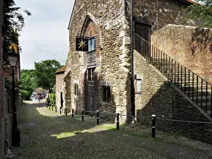 Cobbled Prints: Exploring the historic architecture and streets near the Monastery in Rye East Sussex during a sunny day