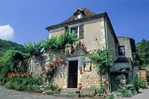 Cobblestone Prints: Exploring a historic building in the village of Saint-Cirq-Lapopie in the Midi-Pyrenees region of France during a sunny