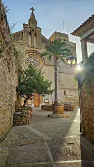 Cobblestone Prints: Exploring the narrow streets and historic buildings of old Alcudia in Mallorca during a sunny day