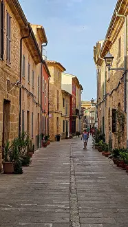 Stones Prints: Exploring narrow streets in the old city of Alcudia during a sunny day in Mallorca, Spain