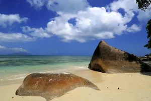 Lovers Prints: Exploring the natural beauty of Beau Vallon Beach in Seychelles with large stones against a clear blue sky