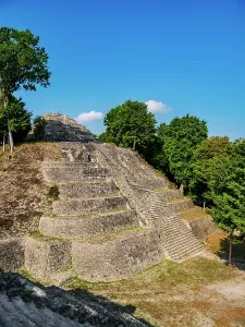 Excavation Prints: Exploring North Acropolis at Yaxha Archaeological Site in Guatemala under clear blue skies