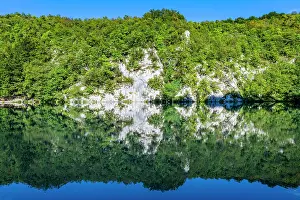 National Prints: Exploring Plitvice Lakes National Park with clear water and forest reflections in Croatia