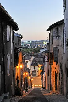Step Prints: Exploring pousterle alley in Auch at dusk with street lights illuminating the path toward the valley