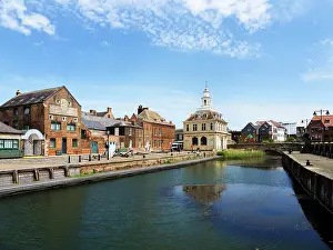 Kings Prints: Exploring Purfleet Quay in Kings Lynn Norfolk with historic buildings and waterway under a clear sky