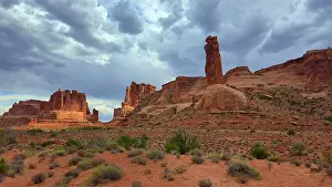 Footpath Prints: Exploring the rock formations and clouds of Arches National Park in Utah during the late afternoon