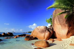 Sailboats Prints: Exploring rock formations by the water on Anse Lazio Beach in Seychelles during a sunny day
