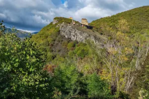 Terrain Prints: Exploring the ruins of Vanati Castle on a hillside in South Ossetia with greenery and cloudy skies