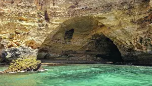 Ecology Prints: Exploring a seacave by the coast of Algarve Portugal during a sunny day with clear waters
